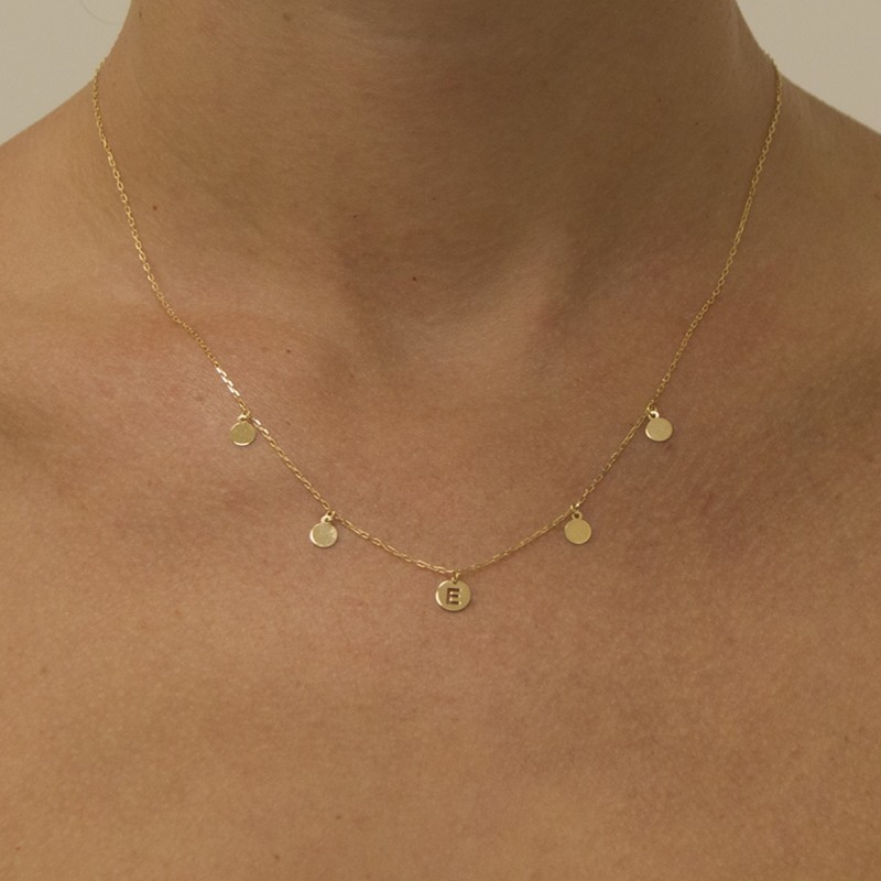 Necklace with a veneer and initial and circles